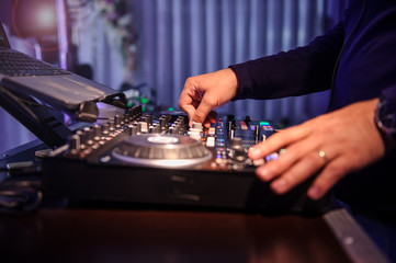 close up photo of a DJ mixing in the dark