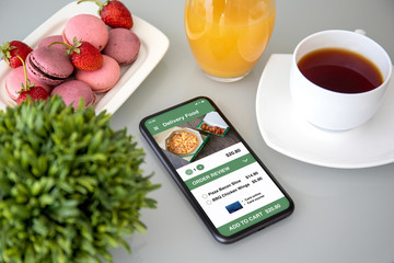 telephone with app delivery food on the screen in cafe