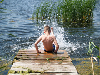 child bathes in the river