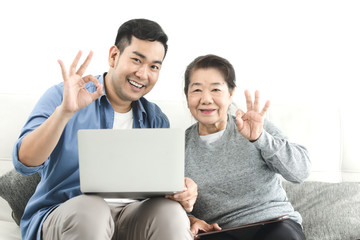 Asian agent man deal with senior for life insurance contract signed, business concept.