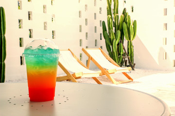 Cool rainbow soda on a chair background