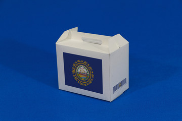 New Hampshire flag on white box with barcode and the color of state flag on blue background. The concept of export trading from New Hampshire.