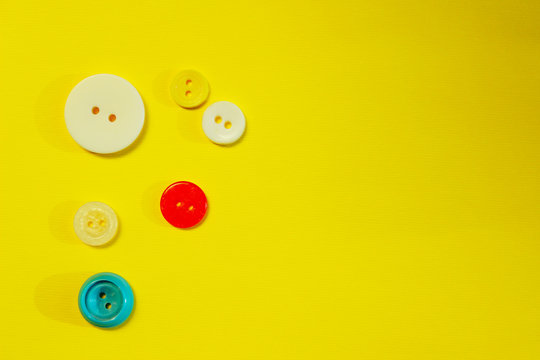 Abstract colorful background. Multi-colored buttons over yellow background, copy space for text. 