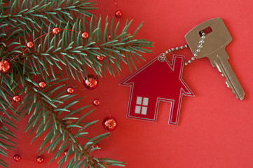 Christmas decoration: decorative house and key to the lock. Concept of finance and housing loans
