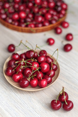 Fresh sweet Cherry on a wooden plate on a table. Natural organic food.