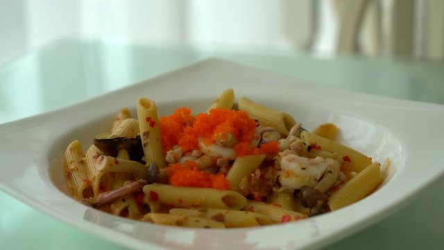 spicy penne seafood on plate