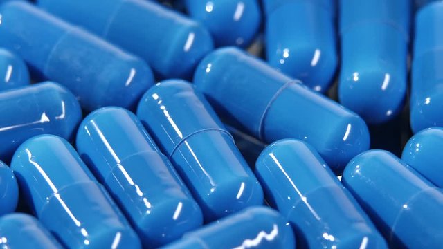 Group of blue medical pills, rotation, close up