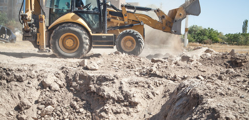 Excavator works at a construction site.