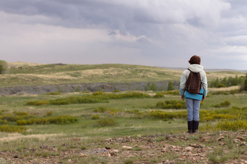 Fototapeta na wymiar woman on top of mountain before the rain in Arkaim