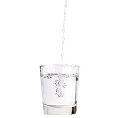 Pour water into a glass isolated with clipping path included.