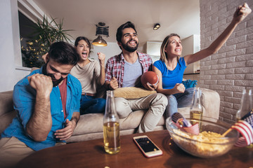 Group of friends sport fans watching rugby match