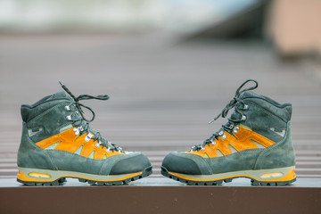 A pair of leather trekking hiking winter boots on blurred background