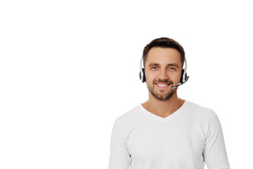 Call center worker man isolated on white background. Young smiling employee telesales agent using...
