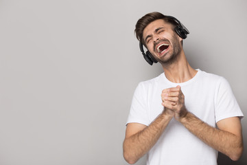 Close up portrait with handsome bearded man loud singing song.