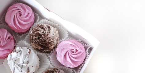Set of homemade marshmallow zephyr in a box on white background