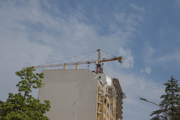 Construction of a new district. Lifting crane build multi-storey buildings