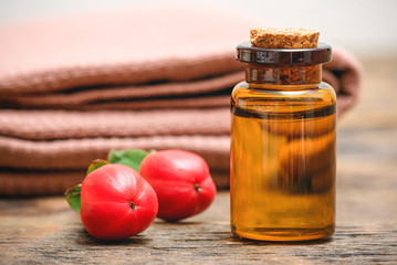 Hypericum plant essential oil and fruits on wooden table. Herbal medicine.