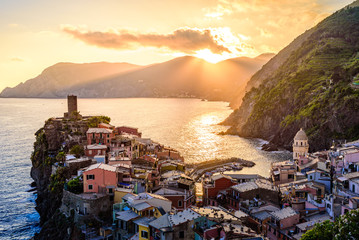 Vernazza - Village of Cinque Terre National Park at Coast of Italy. Beautiful colors at sunset. Province of La Spezia, Liguria, in the north of Italy - Travel destination and attraction in Europe. - obrazy, fototapety, plakaty