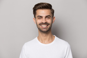 Close up portrait with smiling broadly handsome bearded man.