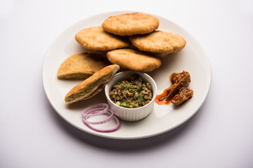 Fried Sattu Litti chokha served with Baingan Bharta, onion and pickle, popular recipe from Bihar, India