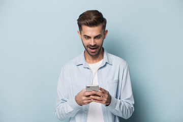 Close up portrait with handsome young man with mobile phone.