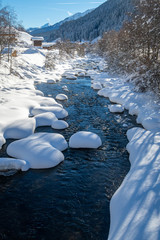 Panoramic view of a snowy creek on a sunny day. Val Ridanna, South Tyrol, Italy