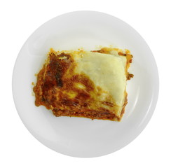 Portion of tasty lasagna. An isolated traditional lasagna made with minced beef bolognaise sauce. Tasty serving of traditional Italian lasagne with spicy tomato based ground beef and melted mozzarella