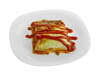 Portion of tasty lasagna. An isolated traditional lasagna made with minced beef bolognaise sauce. Tasty serving of traditional Italian lasagne with spicy tomato based ground beef and melted mozzarella