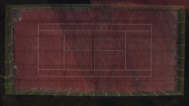 Old red tennis court rising aerial shot top down view