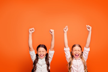 Yeah unbelievable victory. Portrait of lucky delighted crazy two kids girls win contest feel...