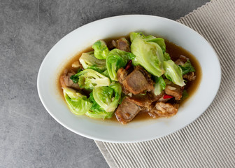Stir Fried Baby Cabbage with Crispy Pork on plate , Asian Food