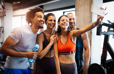 Group of friends having fun at the gym, making a selfie