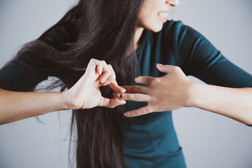woman remove ring on gray background