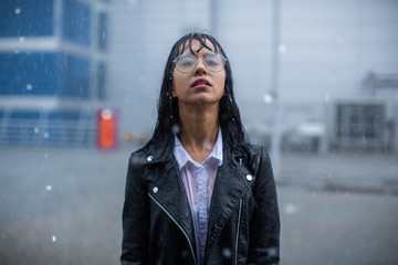 Wet woman standing in the rain.