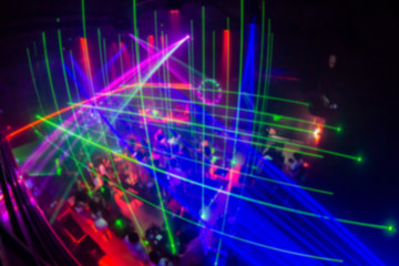 Abstract blur laser And Silhouette hands of audience crowd people enjoying the club party with concert. Blurry night club DJ party people enjoy of music dancing sound.for Background.
