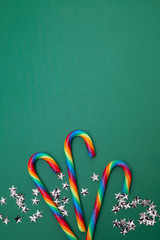 Green Christmas decoration with candy and stars. Top view Merry Christmas and happy new year background.