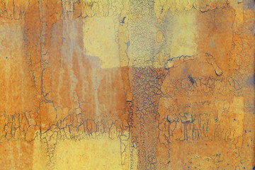 Abstract background. Old yellow cracked stucco on the wall.