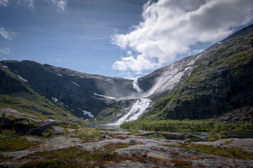Fototapeta na wymiar Waterfall in Husedalen in sunny weather blue skies Norway