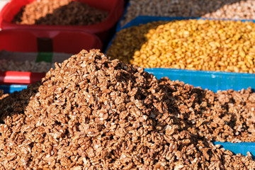 Nuts on the market close-up, dried fruits in the background. East market