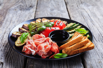 sliced prosciutto ham served with grilled veggies