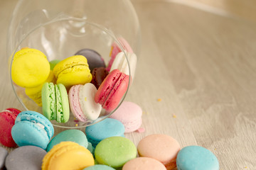 colorful macaroons on vintage wooden background