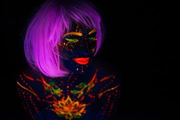 Portrait of Beautiful Fashion Woman in Neon UF Light. Model Girl with Fluorescent Creative Psychedelic MakeUp, Art Design of Female Disco Dancer Model in UV, Colorful Abstract Make-Up. Dancing Lady