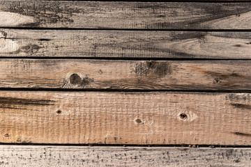 A section of an old wall made of wooden boards of different widths