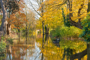 Flooded path and bench by Worcester bridge Worcestershire UK