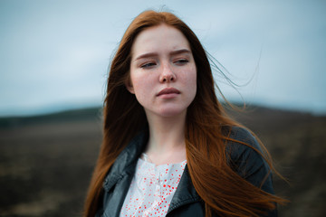 A tragic portrait of a young woman with long red hair.