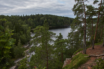 The nature of Karelia.Typical Karelian landscape on the island of Valaam: forest of conifers, Lake Ladoga, crag and volcanic rocks. Russia, Karelia.