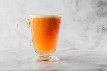 Glass of fresh orange fruit juise isolated on bright marble background. Overhead view, copy space. Advertising for cafe menu. Horizontal photo.