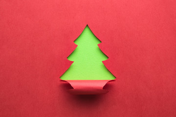 Christmas tree made of green and red paper. New year abstract.
