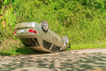 The car had an accident overturned on the road., Car accident overturned on the road., car wreck by...