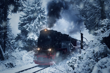 Historical steam locomotive struggles in the dark, through snow and storm to the mountain 